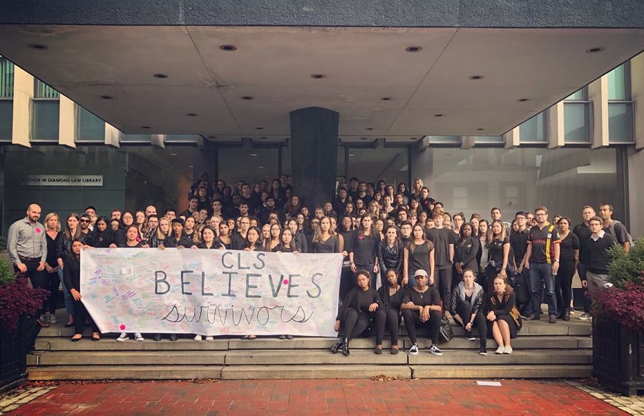 Large group of students at Revson Plaza with "CLS Believes Survivor" banner