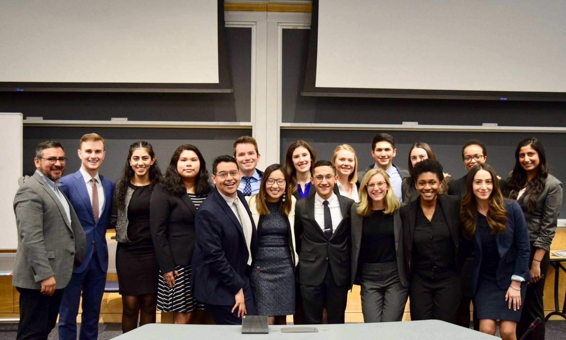 Picture of 15 of our Moot Court Team members and 3 of our judges standing together in a classroom