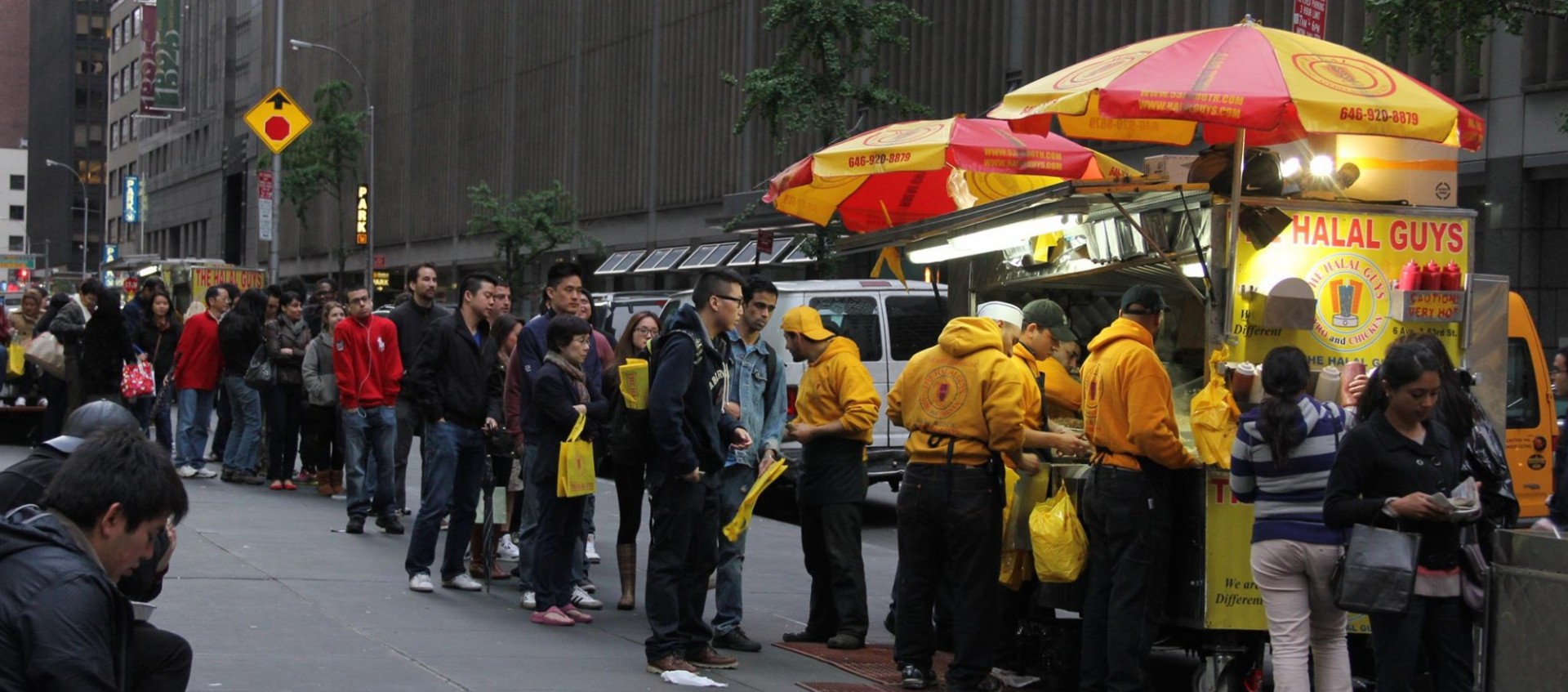 Image of people waiting in line to order from The Halal Guys food truck.