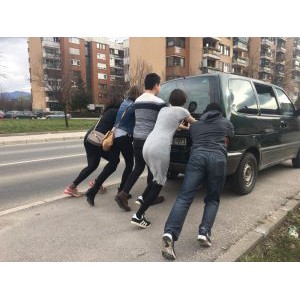 Participants pushing a car