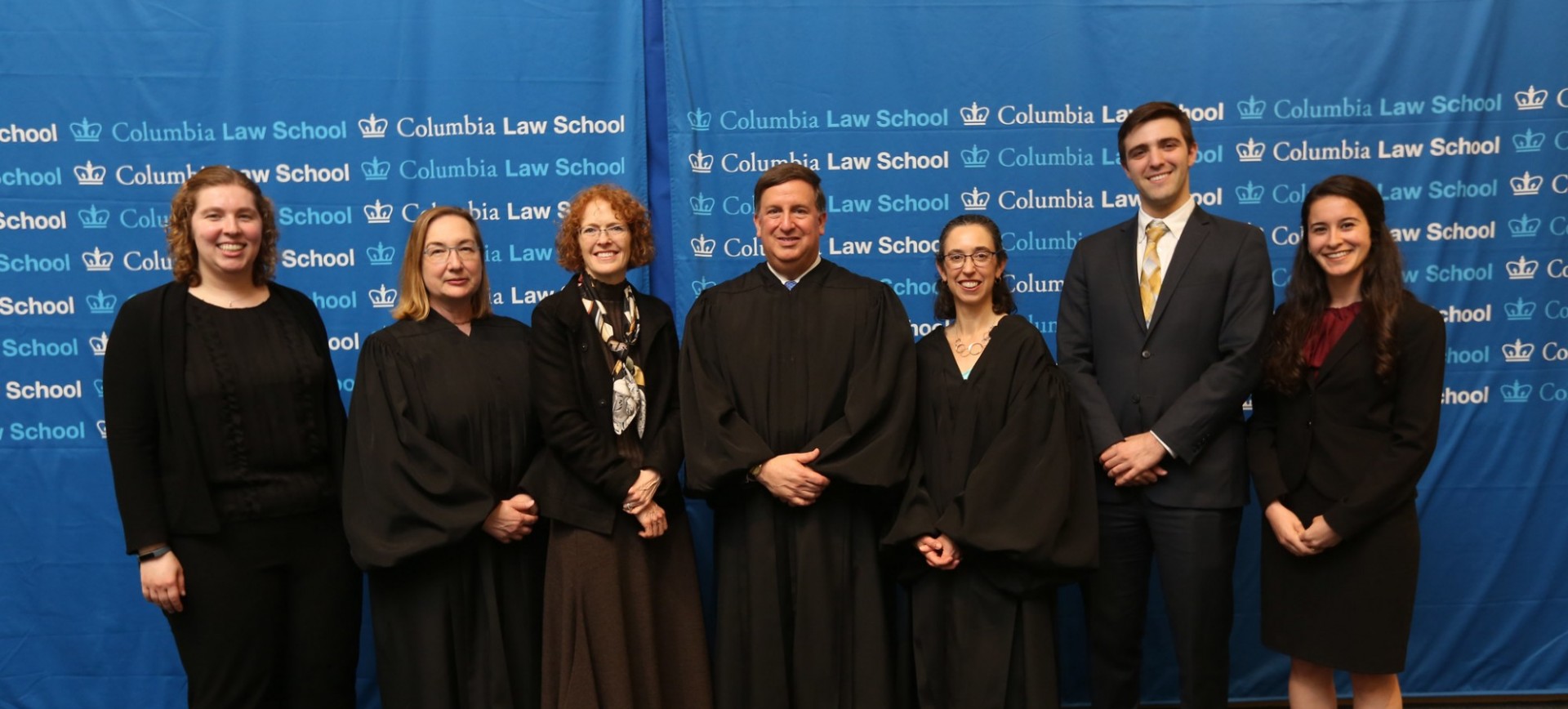 Photo of Dean Gillian Lester with the judges from the 2018 Harlan Fiske Stone Moot Court Final, the student bailiff, and the student directors who wrote the problem.