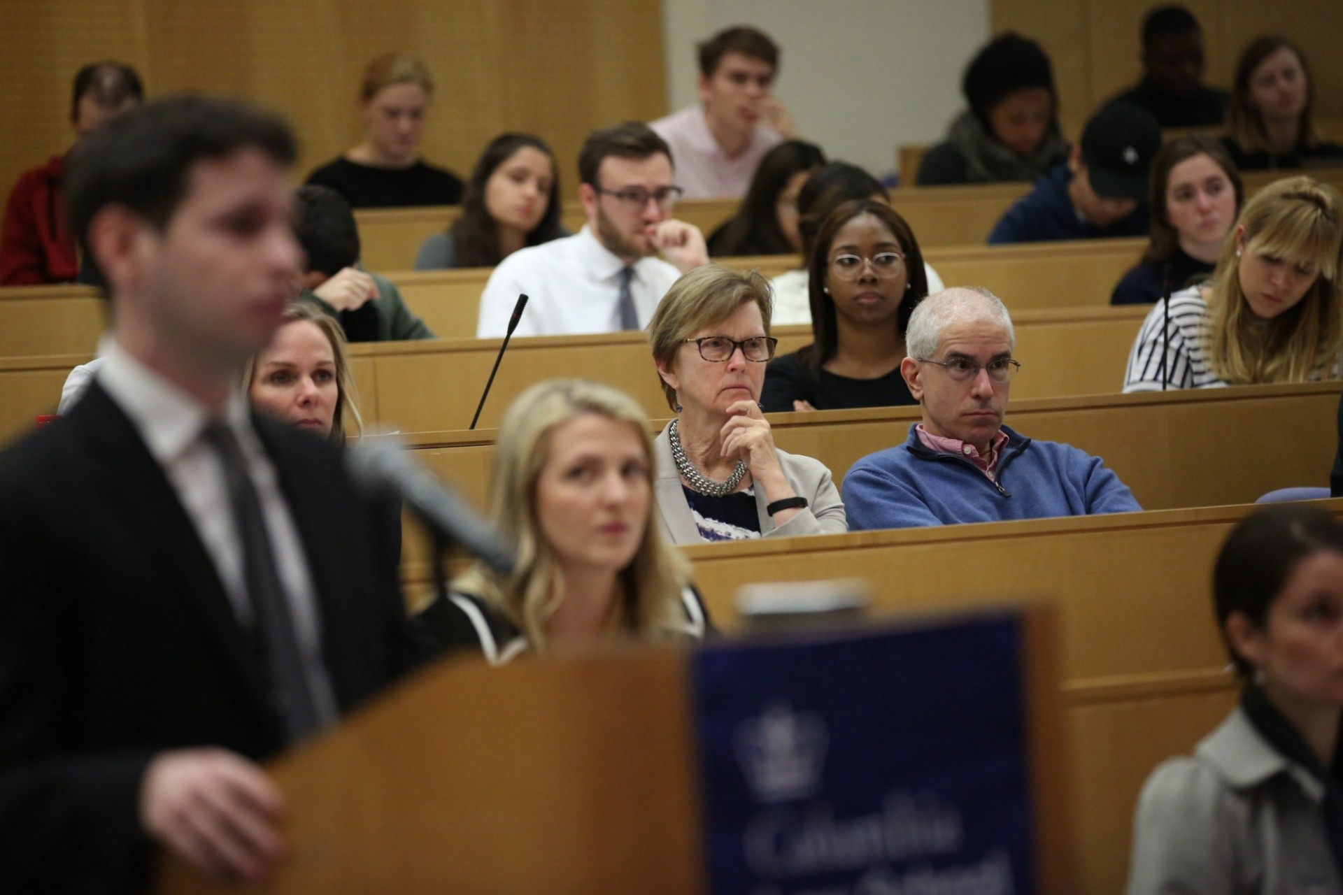 Photo of faculty and students looking on as a Stone finalist answers questions from the panel.